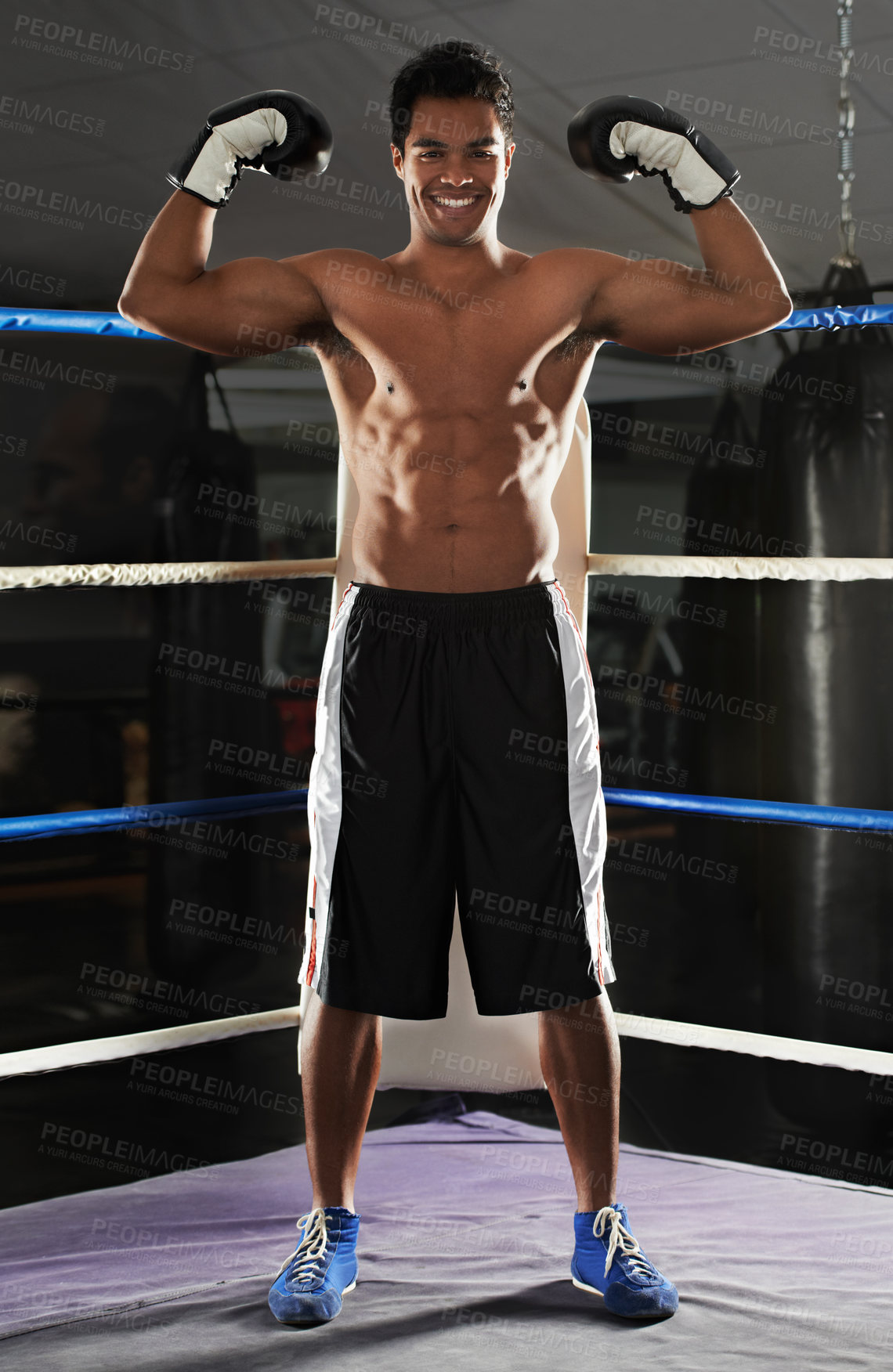 Buy stock photo boxer is smiling because he won, or he just demonstrate his muscules