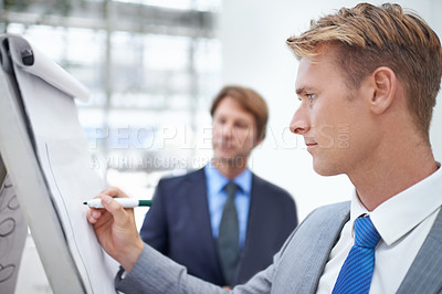 Buy stock photo Face, presentation and whiteboard with business man in boardroom of office for coaching or teaching. Meeting, planning or workshop with young corporate employee writing on paper for development