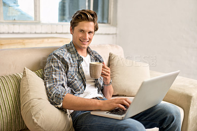 Buy stock photo Man, portrait and laptop on sofa with coffee as freelance journalist for online research, connectivity or networking. Male person, couch and internet for remote work in London, communication or web