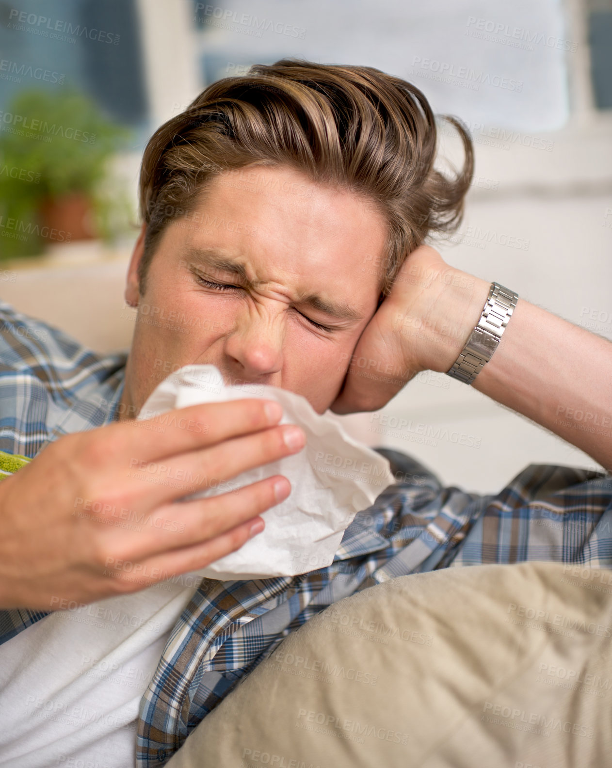 Buy stock photo Sick, flu or man sneezing into tissue on sofa with cold, virus or hay fever at home. Influenza, allergies or person with toilet paper for viral infection, bacteria or coughing with sinusitis in house