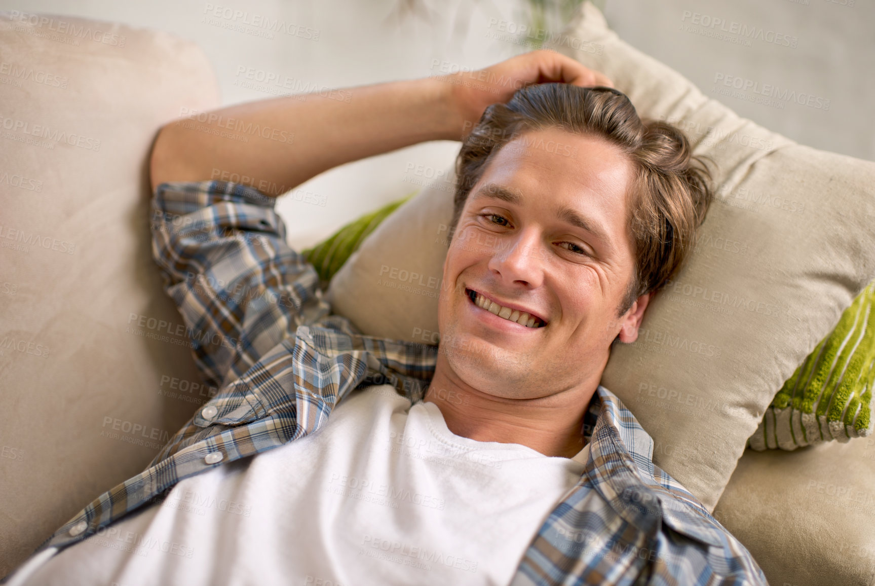 Buy stock photo Man, portrait and relax on sofa in home or comfortable on weekend for lazy vacation, resting or living room. Male person, face and couch in apartment for holiday morning in London, happy or peace