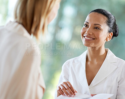 Buy stock photo Shot of a young woman checking in at the reception desk