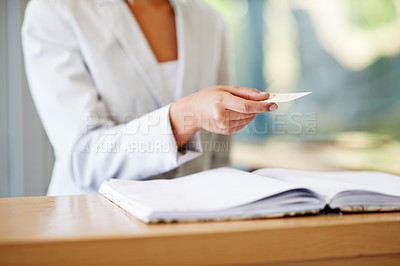 Buy stock photo Woman, hands and business card at reception for information, gift or payment on desk at resort. Hand of female receptionist giving voucher at counter for discount, paying or check in at appointment