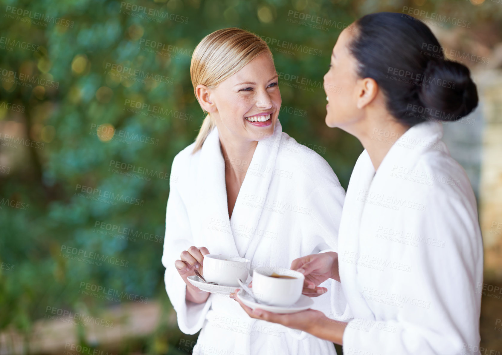 Buy stock photo Spa, coffee and women with a smile, bathrobe and relax with treatment, grooming and chilling. Female people, happy friends or girls with tea, happiness and pampering with wellness, laughing and funny