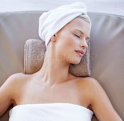 Buy stock photo Young woman, relax and rest in spa for wellness, beauty and peace with body treatment in salon. Person, sleeping or zen on massage bed at luxury resort, detox or comfort for stress free on holiday