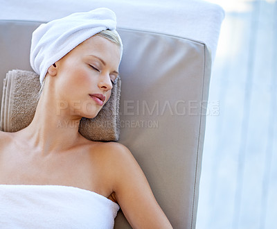 Buy stock photo Young woman, relax and rest in spa for health, wellness and peace with body treatment in salon. Person, sleeping and zen on massage bed for physical therapy, detox and comfort at resort on holiday