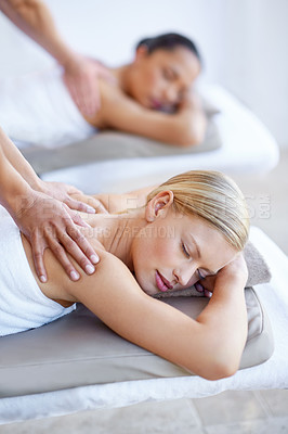 Buy stock photo Back, massage and women relax in spa for skincare, beauty and luxury treatment for wellness and peace. People, rest and hands on person in hotel, salon or on bed for dermatology care of body