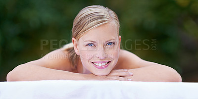 Buy stock photo Spa, woman and happy on massage bed with portrait for wellness, zen and beauty treatment for body care. Person, relax and physical therapy at resort, salon table and luxury on holiday or vacation