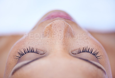 Buy stock photo Cropped shot of an attractive young woman lying on her back