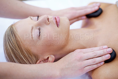 Buy stock photo Hands of masseuse, woman with hot stone massage in spa and healing holistic treatment with zen at luxury wellness resort. Rocks on shoulders, peace with therapy and alternative medicine for self care