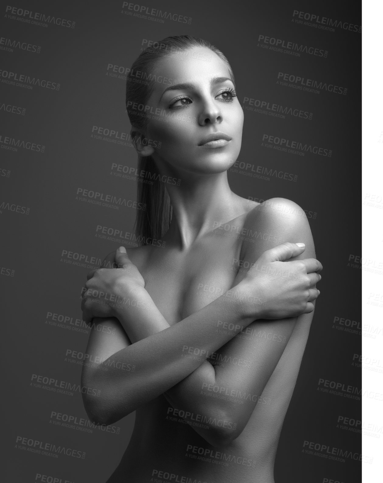 Buy stock photo Black and white shot of an attractive young woman posing topless in studio