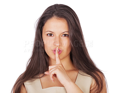 Buy stock photo A young businesswoman with her finger on her lips while isolated on white