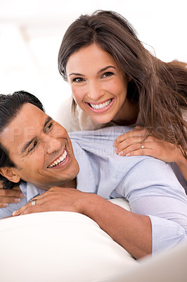 Buy stock photo Relax, laugh and portrait of couple on sofa for weekend bonding, playful romance and connection in home. Love, support and trust in marriage, man and woman on couch with embrace, wellness and smile.