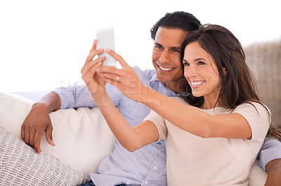 Buy stock photo A beautiful woman taking a photograph of herself and her husband