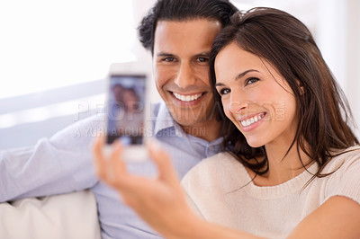 Buy stock photo Happy couple, relax and selfie on sofa for bonding, photography or picture in living room together at home. Young man or woman with smile for photo vlog, picture or social media on couch at house