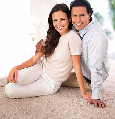Buy stock photo Smile, love and couple on carpet in living room at home with comfortable romance and care. Happy, marriage and portrait of young man and woman relaxing on floor mat together in lounge at house.