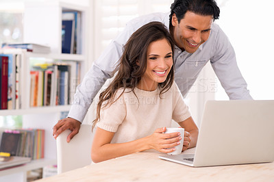 Buy stock photo A husband and wife browsing the internet together indoors