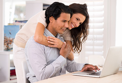 Buy stock photo Happy couple, laptop and hug at table in home for remote work, internet or social media. Computer, man and woman embrace at desk for connection, online shopping and reading email on website with love
