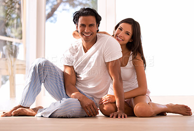 Buy stock photo Mexican couple, portrait and bonding and smiling, indoor and sunset for home in living room. Husband, wife and embrace for love, confident and new house on wooden floor for marriage and happiness