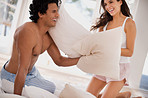 Defending against his wife's pillow assualt