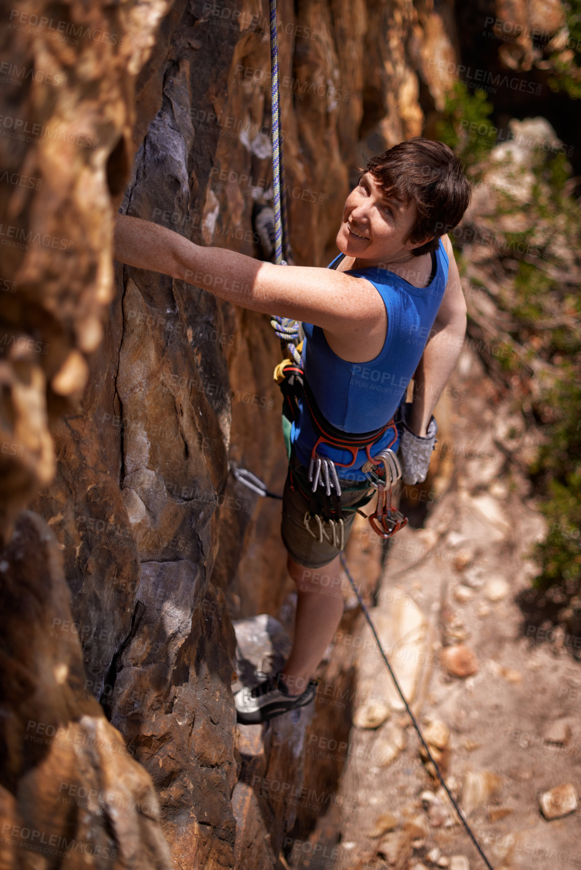 Buy stock photo Rock climbing, woman and portrait with adventure, travel and gear to explore in nature on a mountain. Cliff, hiking and sport above with rope for workout, exercise and climber training outdoor