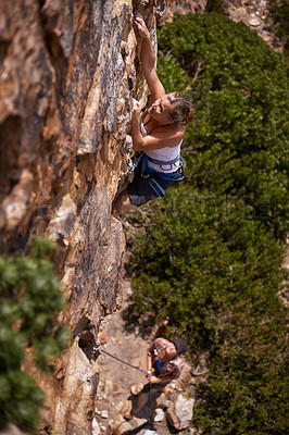 Buy stock photo Woman, mountain and rock climbing for fitness in outdoors, challenge and rope for training. Female person, cliff and extreme sport for exercise or workout, high angle and support to explore in nature