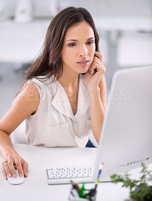 Buy stock photo An attractive young businesswoman working on solving a problem