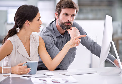 Buy stock photo Two businesspeople conferring with one another on a project