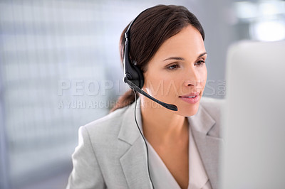 Buy stock photo Young female call center operator with headset, talking to caller in customer service department. Businesswoman in headphones with microphone consulting client on phone in office space.