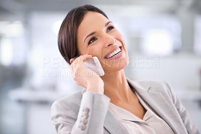 Buy stock photo Shot of a woman using a cellphone while sitting at a desk in an office