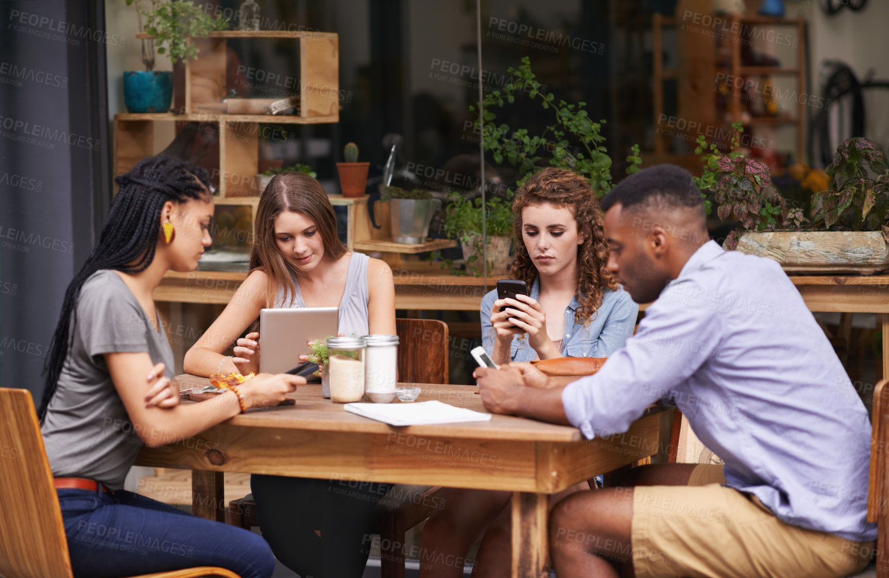 Buy stock photo Technology, diversity and friends in restaurant together for social gathering with phone, tablet and networking. Coffee shop, brunch and people relax at sidewalk cafe with text, email or digital app.