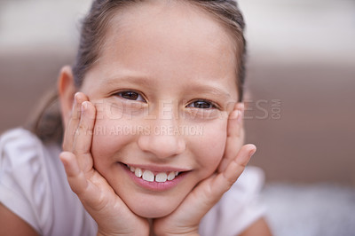 Buy stock photo A young girl with her hands on her face smiling at the camera - close-up