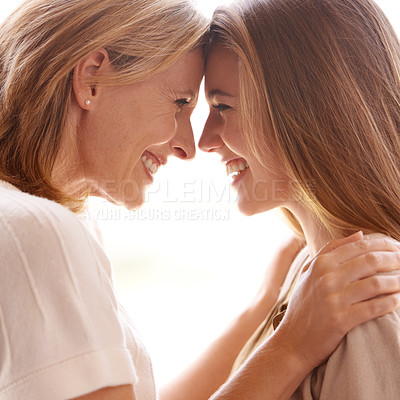 Buy stock photo A mother and daughter standing face to face and showing each other affection