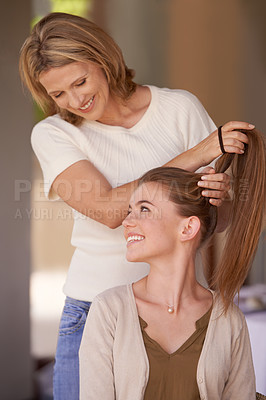 Buy stock photo Women, mother and daughter in home, hairdresser or happy for helping hand, conversation and family home. People, girl and mature mom with hair care, talking and smile with love, connection or bonding