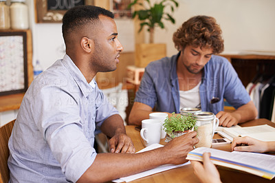 Buy stock photo Man, students and studying in coffee shop with textbook or friends or university education, course or learning. Male people, cup and collaboration in cafe or scholarship or college, degree or exam