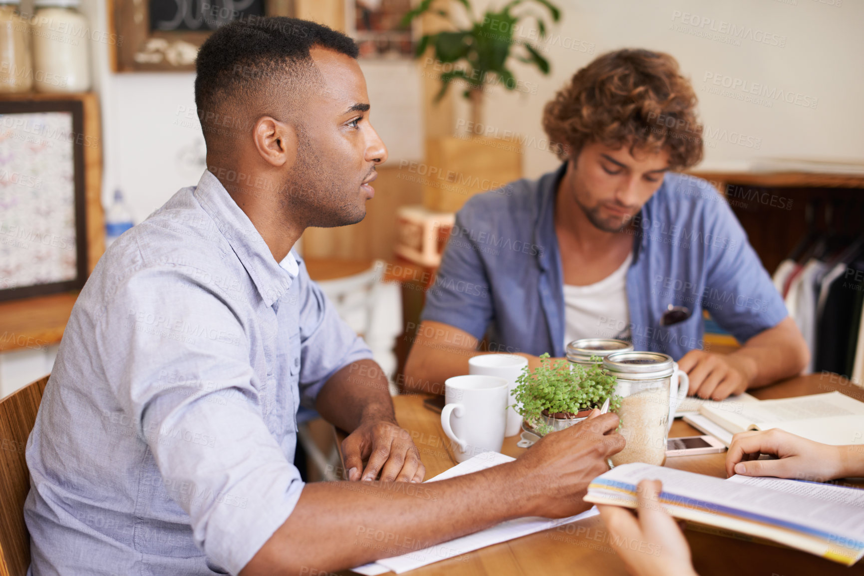 Buy stock photo Man, students and studying in coffee shop with textbook or friends or university education, course or learning. Male people, cup and collaboration in cafe or scholarship or college, degree or exam