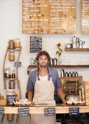 Buy stock photo Portrait of a male barista standing at a cafe counter