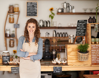Buy stock photo Portrait of an attractive young barista starting at a cafe counter