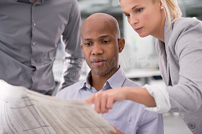 Buy stock photo Business people, newspaper and pointing to information for reading, teamwork or crossword game at office. Colleagues or employees with document or paper for problem solving or planning at workplace