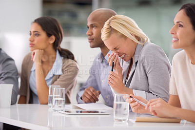 Buy stock photo Shot of a businesswoman sneezing during a meeting with her colleagues
