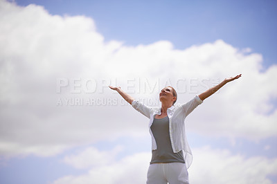 Buy stock photo A mature woman with arms outstretched