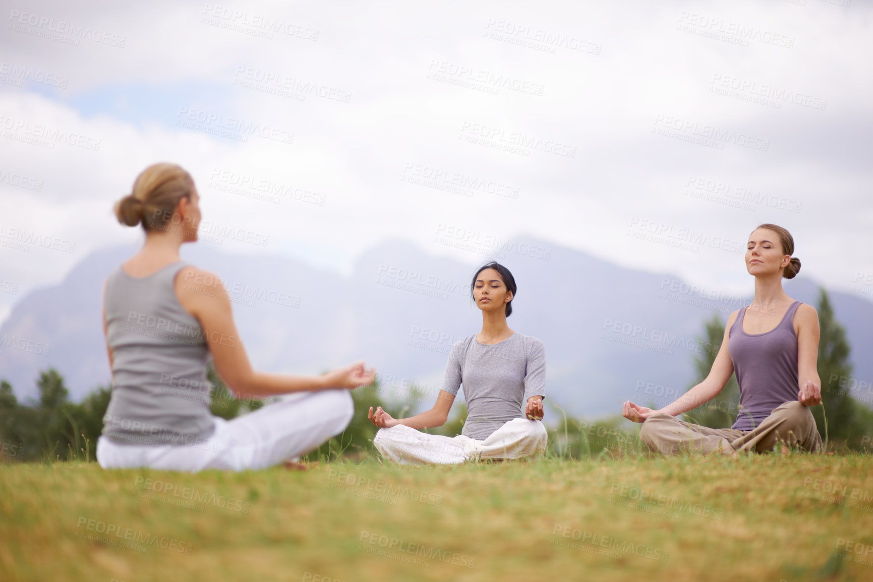 Buy stock photo Lotus, instructor and meditation outdoor for yoga, healthy body and mindfulness exercise to relax. Peace, group and calm women in padmasana in nature for balance, spirituality or breathing together
