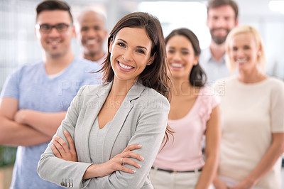 Buy stock photo Shot of a confident businesswoman standing in front of her coworkers