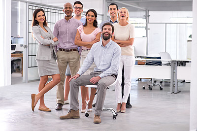 Buy stock photo Full length shot of a smiling businessman sitting in front of his coworkers
