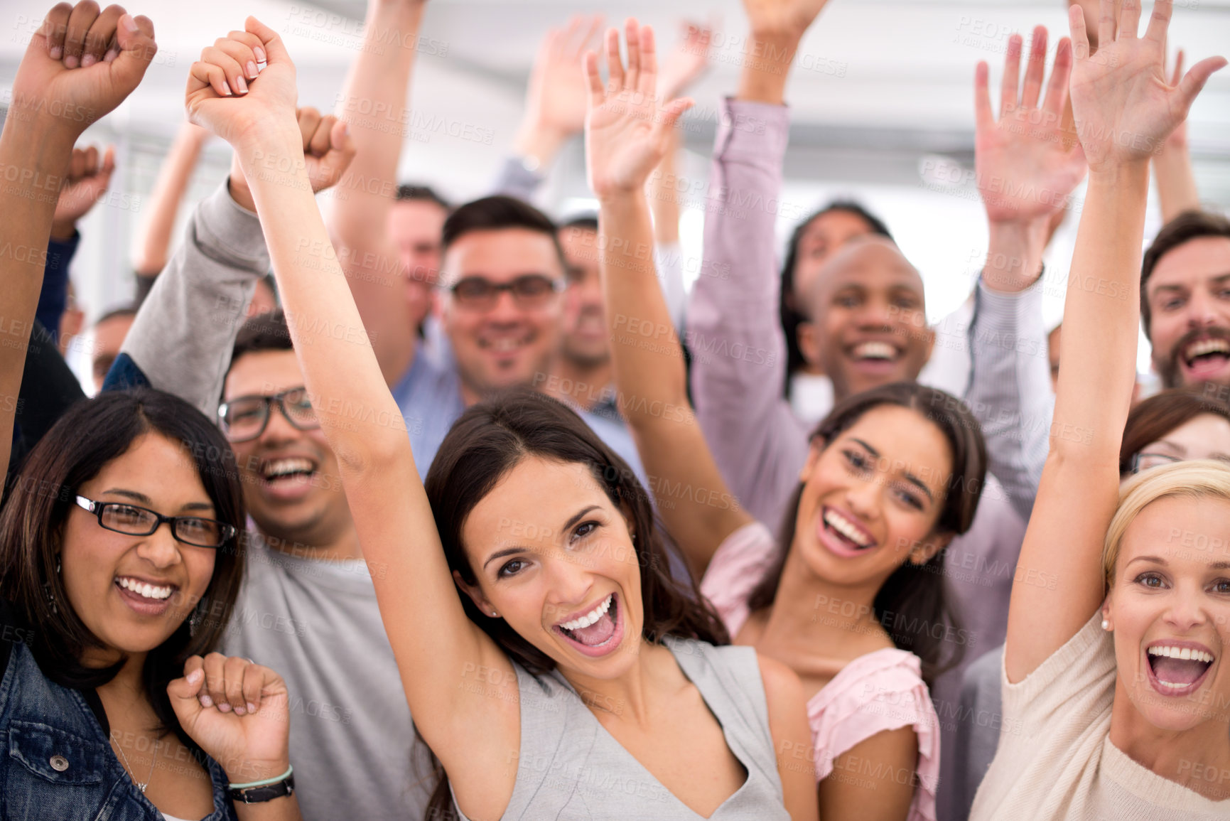 Buy stock photo Shot of a group of smiling businesspeople raising their hands