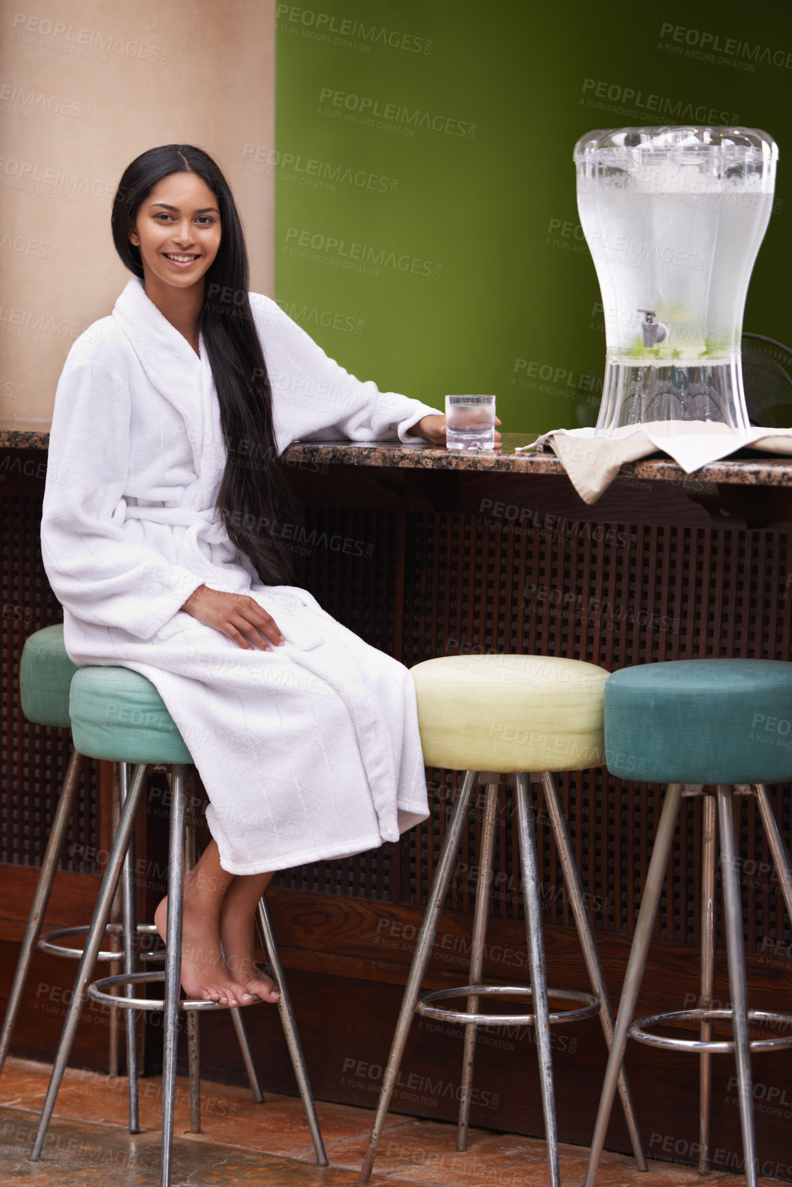 Buy stock photo A young woman in a robe enjoying a glass of water