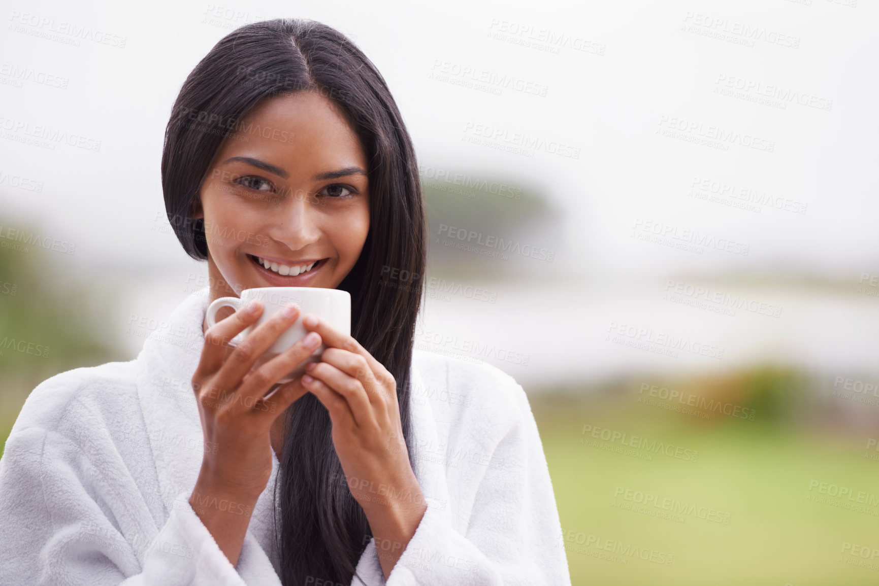 Buy stock photo A beautiful young woman enjoying a cup of coffee while wearing a bathrobe