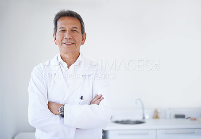 Buy stock photo Portrait of a mature male surgeon standing in the hospital