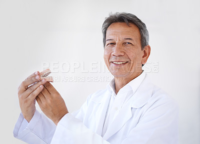 Buy stock photo Man, dentist and portrait with denture mold for teeth healthcare for treatment with oral care, consulting or white background. Male person, veneers and mockup in studio or clinic, whitening or clean