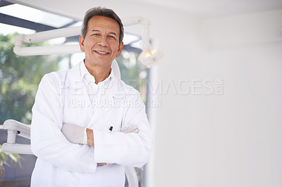 Buy stock photo Portrait of a mature male dental surgeon standing in his office
